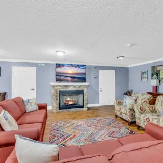 A cozy living room featuring a fireplace, comfortable seating, and a relaxing atmosphere.