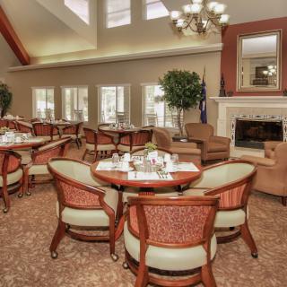 A cozy dining area with elegant furnishings and a fireplace.