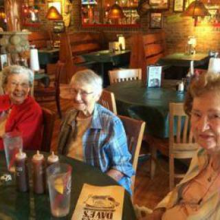 A group of seniors enjoying a meal together at a restaurant.
