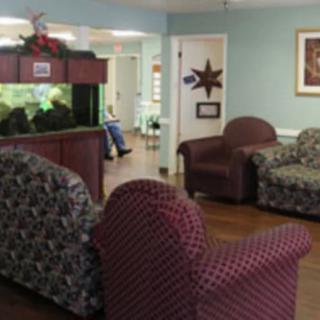 A cozy seating area with patterned sofas and an aquarium.