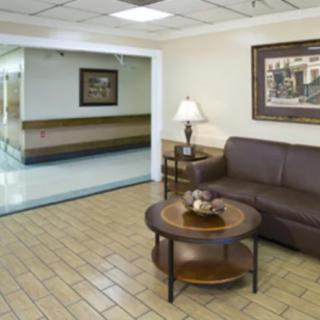 A quiet waiting area with a brown sofa, coffee table, and decorative items.