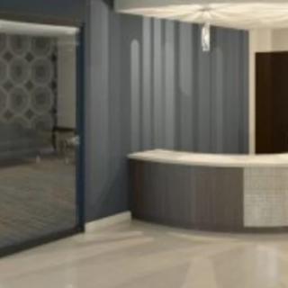 A modern, minimalist reception area with a sleek desk and neutral colors.