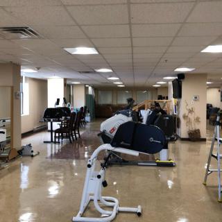 An indoor gym with various exercise machines and equipment.