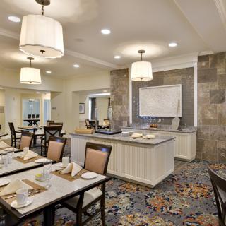 A modern dining room with elegant lighting and contemporary furnishings.