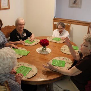 A group of seniors playing bingo together at a table.