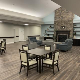 A modern lounge area with comfortable seating and a fireplace.