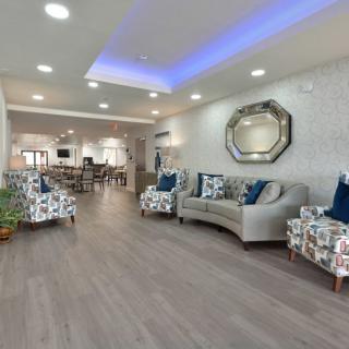 A modern living room with stylish furniture and ambient lighting.