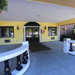 The welcoming entrance of a brightly colored building with decorative lanterns.