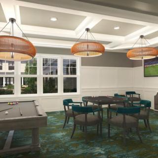 A well-lit game room featuring a pool table and a seating area.