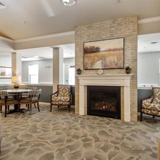 A cozy living room with a fireplace and elegant seating arrangement.