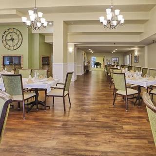 Elegant dining room with neatly arranged tables and chandeliers.