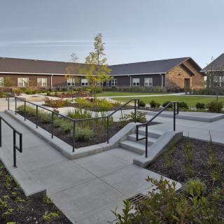 A modern courtyard surrounded by buildings with well-maintained landscaping and pathways.