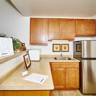 A modern kitchen with wooden cabinets and stainless steel appliances.