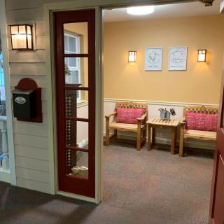 A cozy waiting room with comfortable seating and warm lighting.