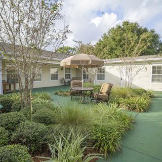 A serene courtyard with lush greenery and outdoor seating.
