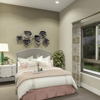 A cozy and elegantly decorated bedroom with modern wall art and a view of the garden.