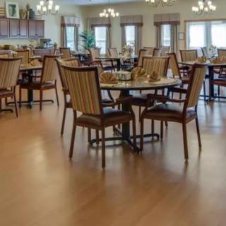 An empty dining room with neatly arranged tables and chairs.