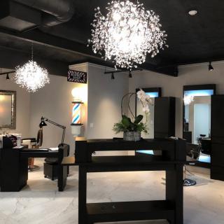 A modern salon interior with elegant chandeliers and stylish furnishings.