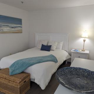 A cozy and inviting bedroom featuring a serene coastal theme with blue accents.