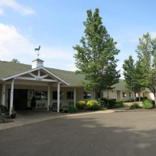 A charming residential building with landscaped surroundings, featuring a welcoming entrance.