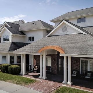 A large suburban house with a front porch and columns.