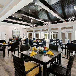A modern restaurant dining area with neatly arranged tables and chairs.