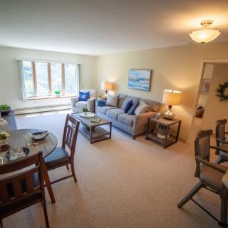 Cozy living and dining area with comfortable furniture and natural light.