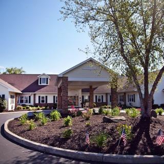 A well-landscaped building with a garden and trees.
