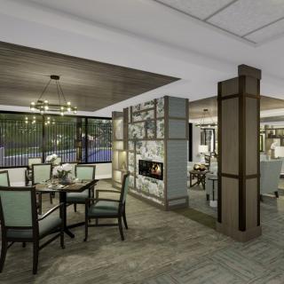 A modern dining area with elegant furniture and a cozy fireplace.