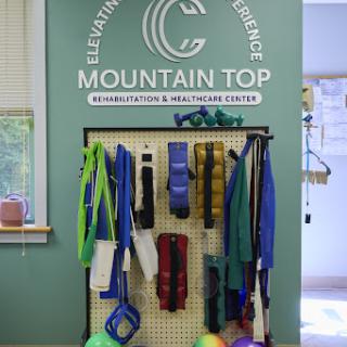 A display of various fitness and rehabilitation equipment at Mountain Top Wellness Center, promoting health and active living.