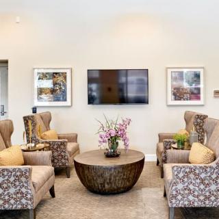A modern living room with comfortable seating, a coffee table, and a mounted television.