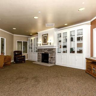 A spacious living room featuring a fireplace surrounded by built-in shelves and comfortable seating.