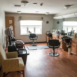 A cozy salon interior with chairs and hairdressing equipment.