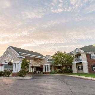 A residential building with a parking lot at sunset.