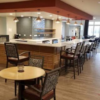 A modern caf interior featuring a bar area with stylish seating and contemporary decor.