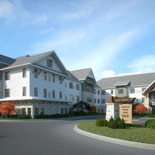 A scenic view of a hotel building with landscaped surroundings and a clear sky.