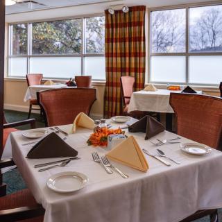 Elegant dining area with neatly set tables and warm decor.