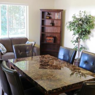 A cozy dining area with a marble table and comfortable seating.