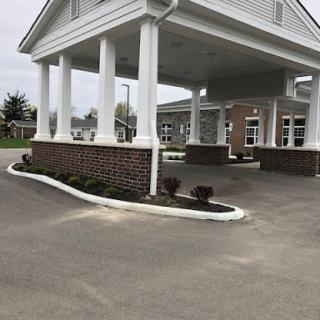 A view of the entrance area featuring a covered pavilion and landscaped surroundings.