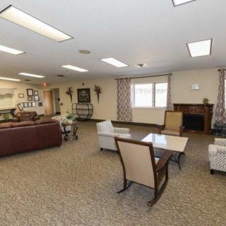 A spacious living room with comfortable seating and a fireplace.