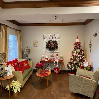 A beautifully decorated living room ready for the holiday season, featuring a Christmas tree and festive decor.