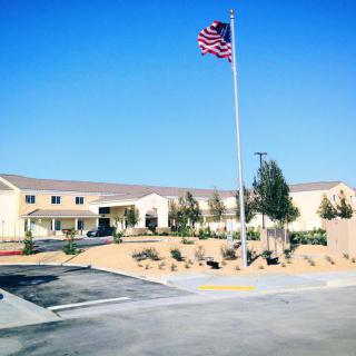 A building with an American flag flying on a clear, sunny day.