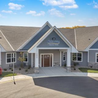 A suburban residential building with a peaked roof and a welcoming entrance.
