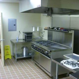 A clean and organized commercial kitchen with stainless steel appliances.