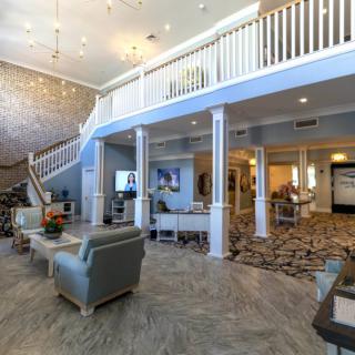 A spacious and modern lobby with comfortable seating and decorative elements.