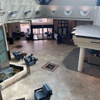 A spacious lobby with seating areas and a modern design.