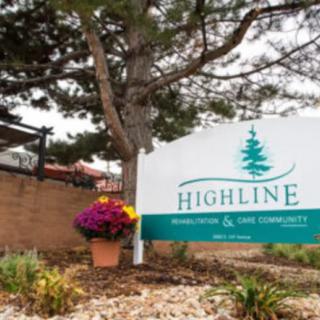 An outdoor sign for Highline Medical & Wellness Center surrounded by trees and landscaped flowers.