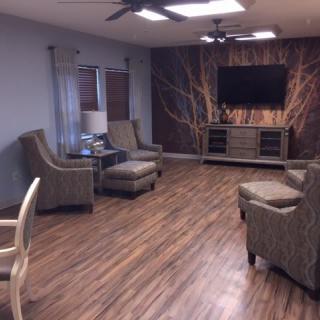 A modern living room with comfortable seating and a large television.