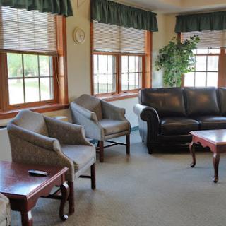 A cozy living room featuring comfortable seating and ample natural light.