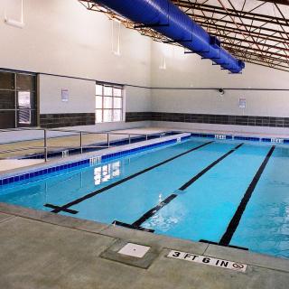 An indoor swimming pool with lanes marked for lap swimming.